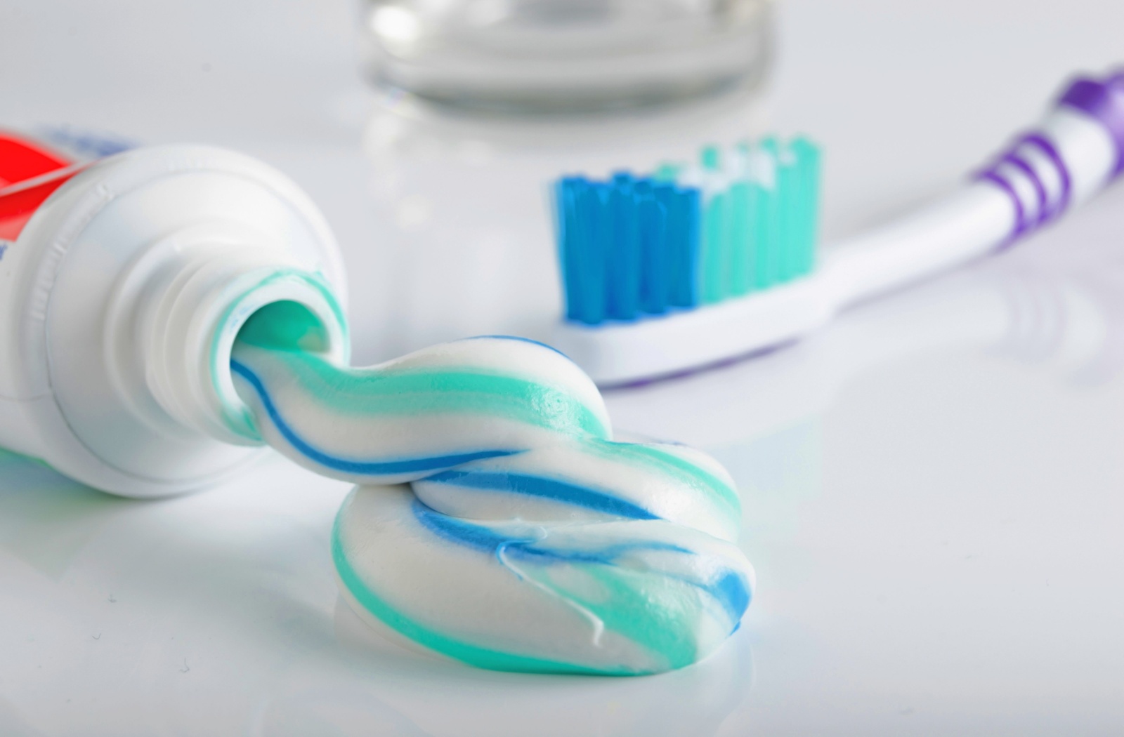 A close-up photo of toothpaste and a toothbrush.