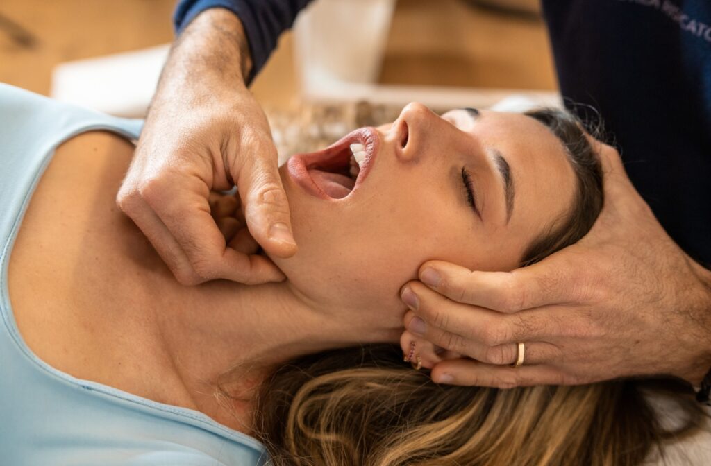 A person having a TMJ massage due to TMJ pain.